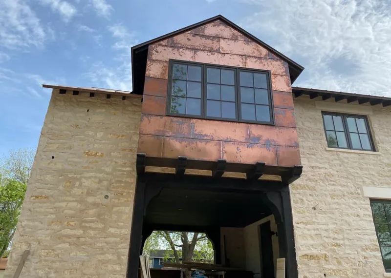 Copper metal panel facade on a stone building for Skylight Installation in Atascadero